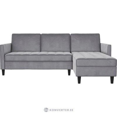 Pilkos spalvos aksominė kampinė sofa-lova presley su grožio trūkumais.
