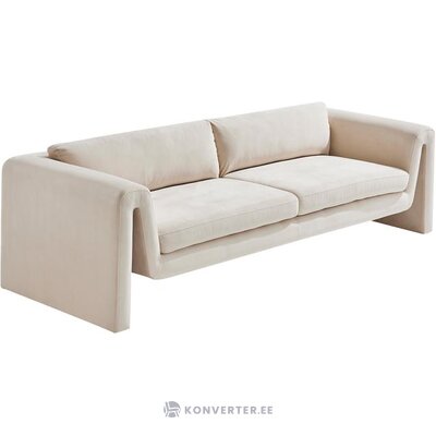 Beige sohva, jossa kiille (imeskelytabletti) kauneusvirhe